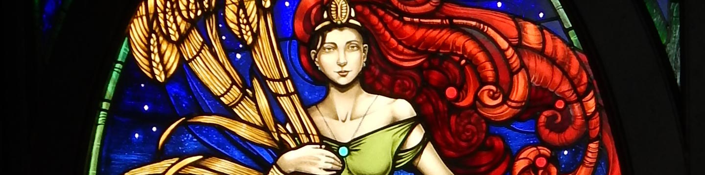 A stained art piece depicting Ninkasi, the Sumerian goddess of beer